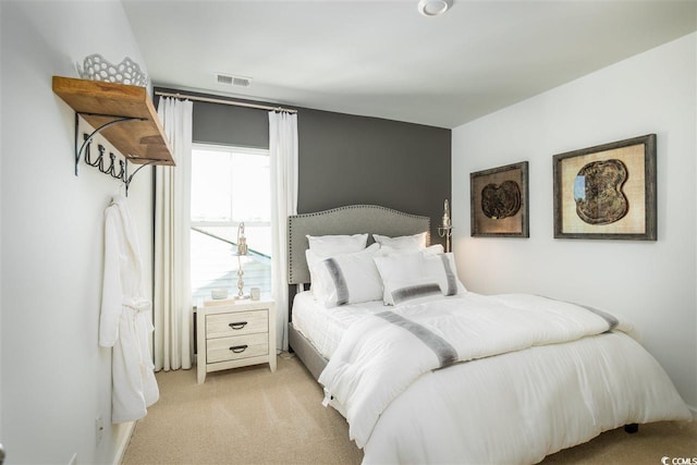 bedroom featuring light carpet