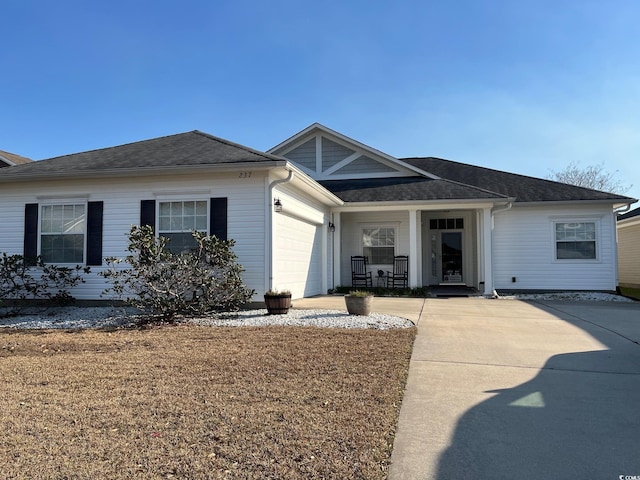 237 Cloverleaf Dr, Longs, SC 29568 - single story home featuring covered porch, an attached garage, driveway, and a shingled roof