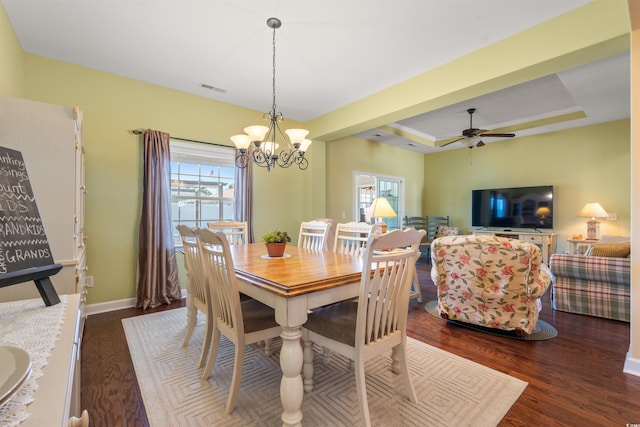 237 Cloverleaf Dr, Longs, SC 29568 - dining area with visible vents, wood finished floors, baseboards, a raised ceiling, and ceiling fan with notable chandelier