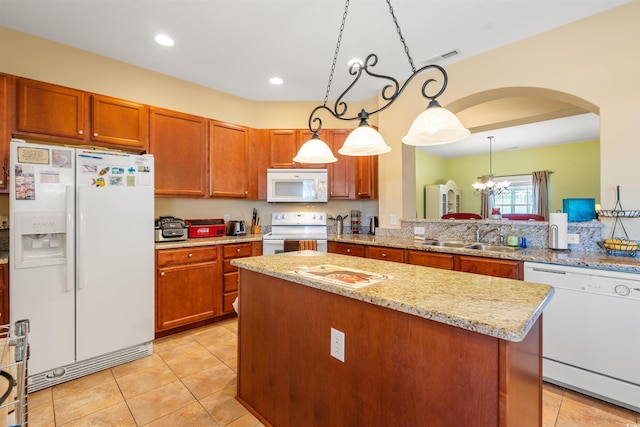 237 Cloverleaf Dr, Longs, SC 29568 - kitchen with a sink, a kitchen island, white appliances, arched walkways, and hanging light fixtures