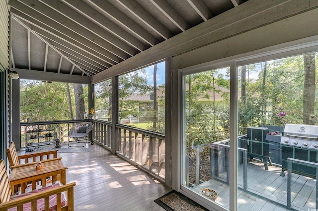 sunroom featuring vaulted ceiling