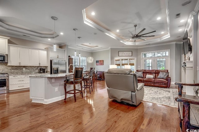 8556 Juxa Dr, Myrtle Beach, SC 29579 - kitchen with a wealth of natural light, a tray ceiling, and stainless steel appliances