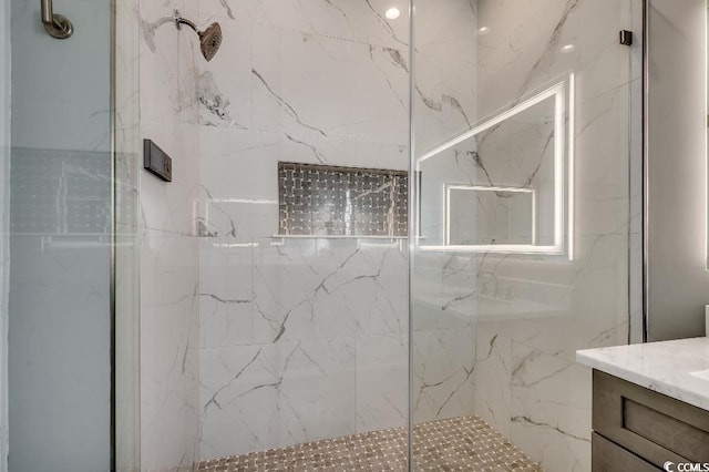 full bath featuring vanity and a marble finish shower