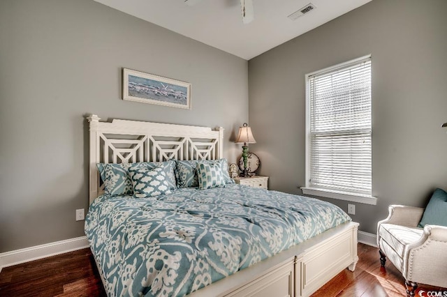 bedroom featuring multiple windows, wood finished floors, and visible vents