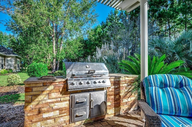 view of patio featuring exterior kitchen and grilling area