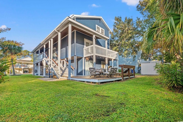 rear view of property with a lawn and a deck