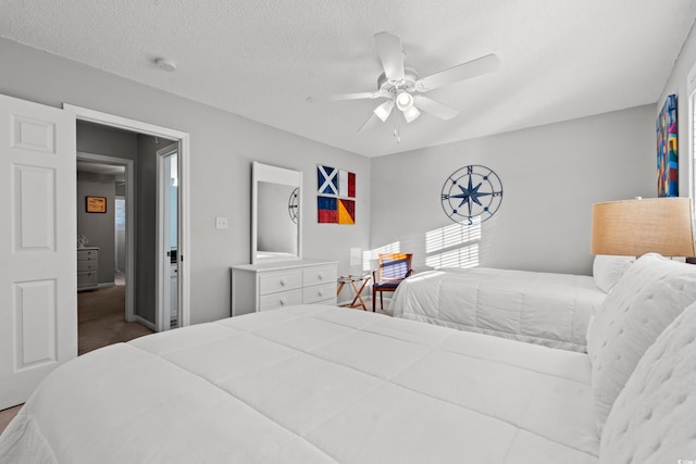 carpeted bedroom with a textured ceiling and ceiling fan