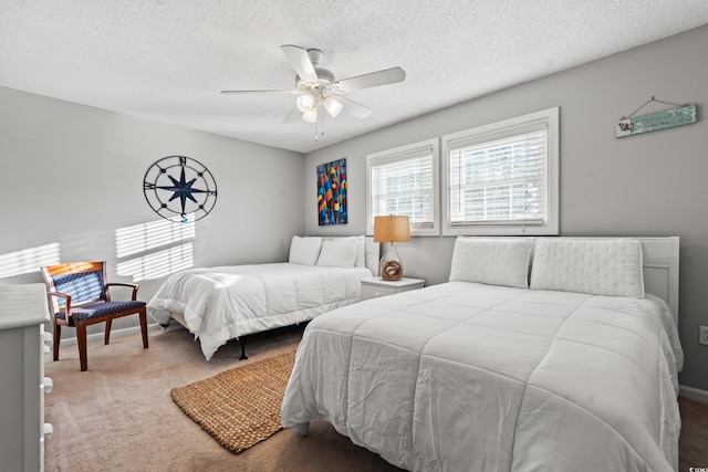 bedroom with a textured ceiling, carpet floors, and ceiling fan