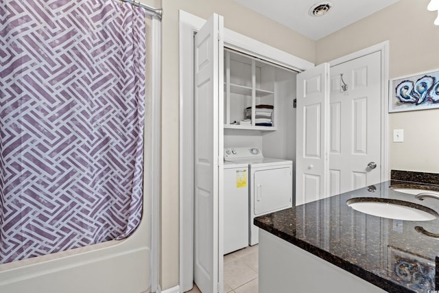 bathroom featuring vanity, washing machine and dryer, tile patterned floors, and shower / bath combo with shower curtain