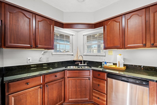 kitchen featuring dishwasher, dark stone counters, sink, and a textured ceiling