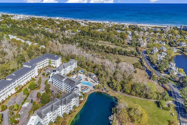 aerial overview of property's location with a large body of water and apartment complex / building