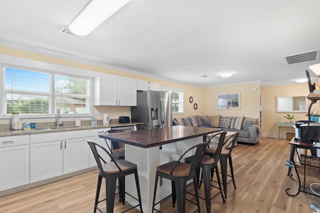 kitchen with white cabinets, a wealth of natural light, sink, and appliances with stainless steel finishes