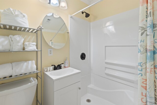 bathroom featuring toilet, ornamental molding, vanity, and curtained shower