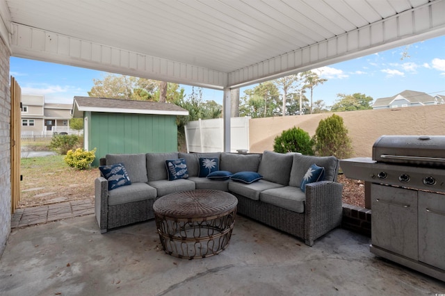 view of patio / terrace featuring a storage unit and an outdoor living space