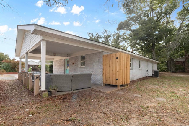 back of property featuring central AC unit and an outdoor hangout area