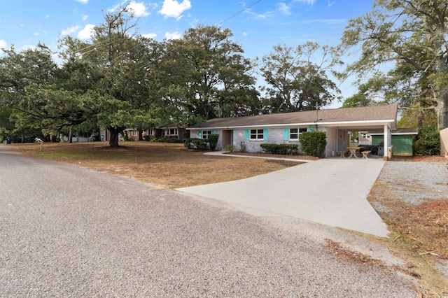 view of front of property with a front lawn and a carport