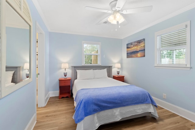 bedroom with light wood-type flooring, ceiling fan, and crown molding