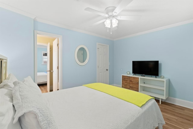 bedroom featuring hardwood / wood-style flooring, ceiling fan, and crown molding