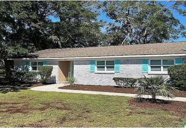 ranch-style house with a front lawn