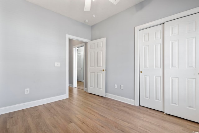 unfurnished bedroom with ceiling fan, a closet, and light hardwood / wood-style flooring