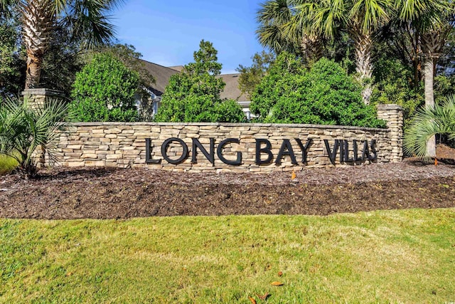 community sign featuring a lawn