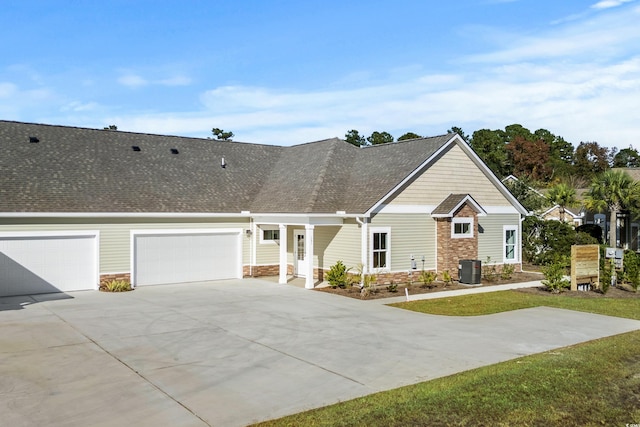 view of front of house featuring central AC and a garage