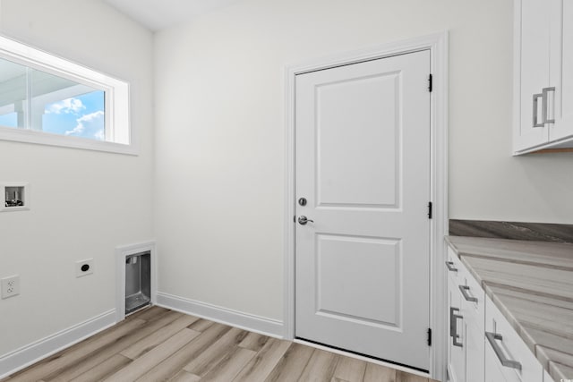 washroom featuring light hardwood / wood-style flooring, cabinets, hookup for an electric dryer, and hookup for a washing machine