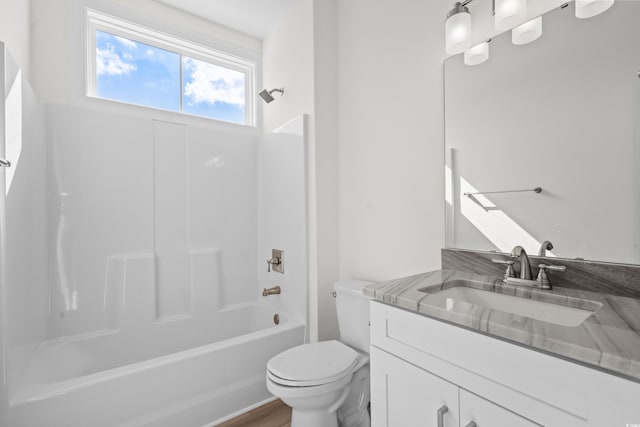 full bathroom featuring toilet, tub / shower combination, wood-type flooring, and vanity