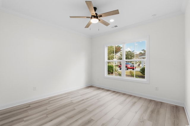 spare room featuring light wood-type flooring, ceiling fan, and crown molding