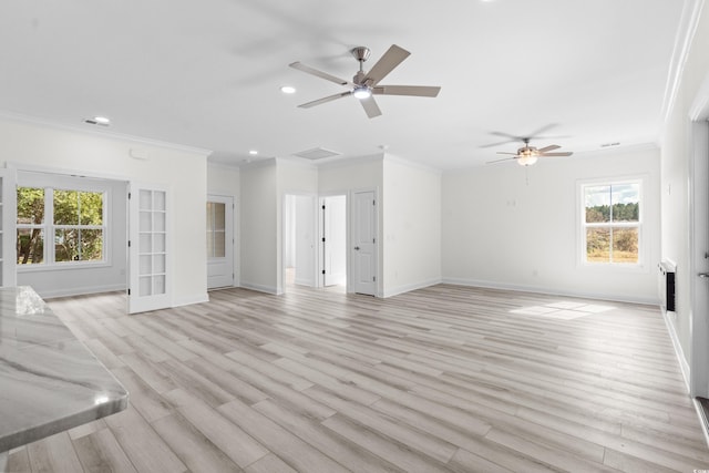 unfurnished living room with ornamental molding, ceiling fan, and a healthy amount of sunlight