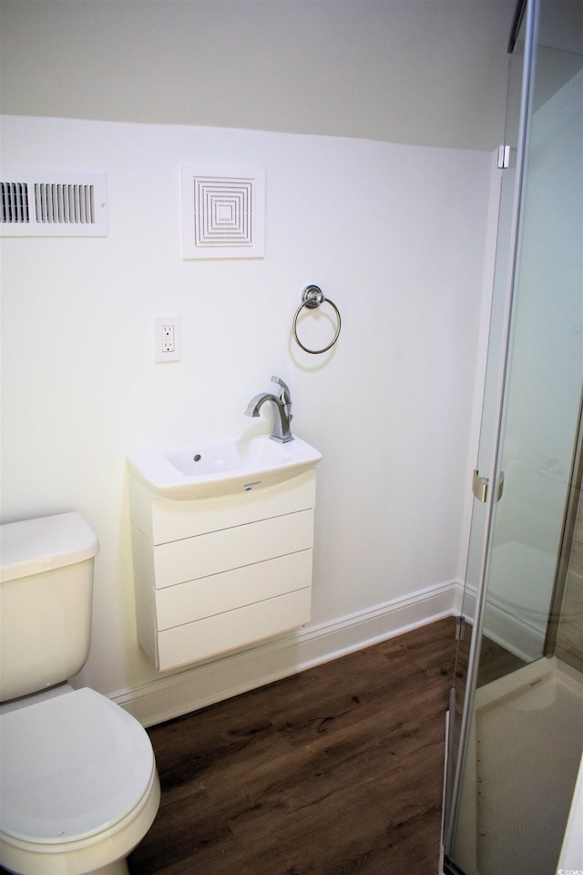 full bath featuring visible vents, toilet, a stall shower, wood finished floors, and baseboards