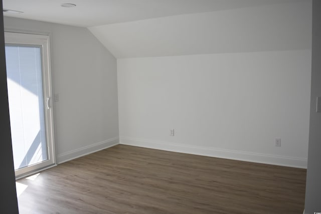 bonus room with baseboards, wood finished floors, and vaulted ceiling