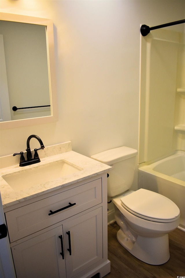 full bath featuring vanity,  shower combination, toilet, and wood finished floors