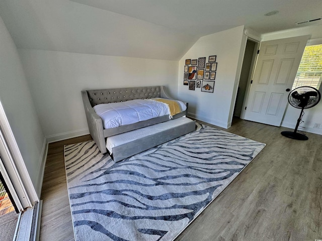 37 Geney Ln, Pawleys Island, SC 29585 - bedroom featuring baseboards, visible vents, wood finished floors, and vaulted ceiling