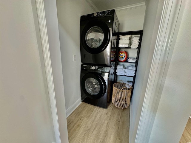 37 Geney Ln, Pawleys Island, SC 29585 - laundry room featuring crown molding, baseboards, stacked washer and dryer, and wood finished floors