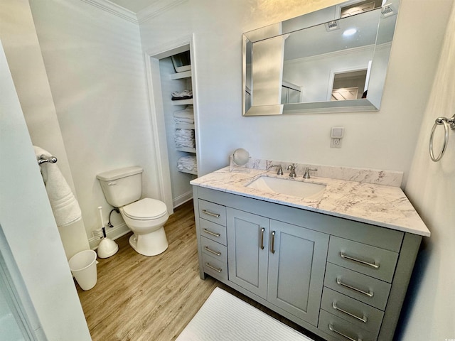 37 Geney Ln, Pawleys Island, SC 29585 - bathroom with wood finished floors, vanity, baseboards, toilet, and ornamental molding