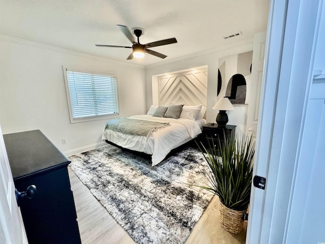 37 Geney Ln, Pawleys Island, SC 29585 - bedroom with visible vents, ornamental molding, baseboards, and wood finished floors