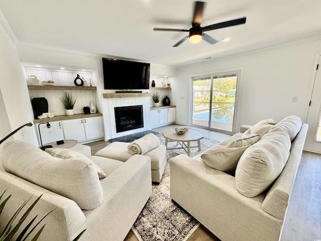 37 Geney Ln, Pawleys Island, SC 29585 - living area featuring crown molding, light wood finished floors, ceiling fan, and a fireplace