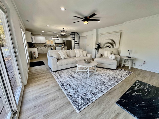 37 Geney Ln, Pawleys Island, SC 29585 - living room featuring crown molding, stairs, recessed lighting, light wood-type flooring, and a ceiling fan