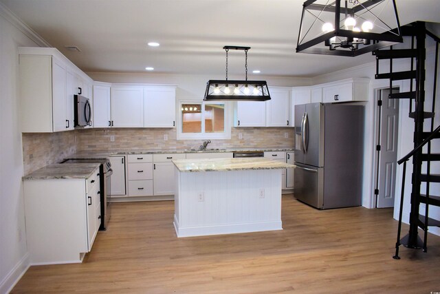 37 Geney Ln, Pawleys Island, SC 29585 - kitchen featuring white cabinets, appliances with stainless steel finishes, a sink, light wood finished floors, and backsplash