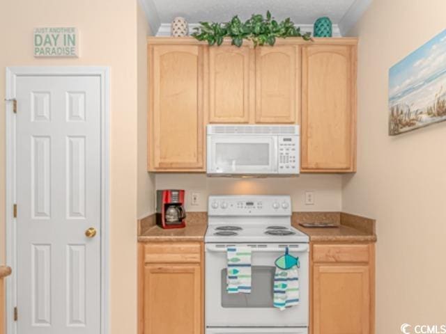 kitchen featuring light brown cabinetry and white appliances