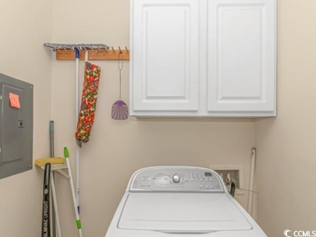 laundry room with electric panel, cabinets, and washer / clothes dryer