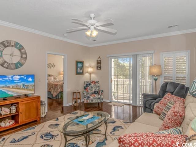 living room featuring crown molding, hardwood / wood-style flooring, and ceiling fan