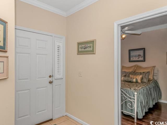 tiled entrance foyer with crown molding