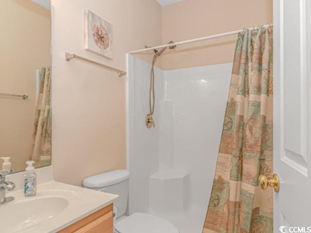 bathroom with vanity, a shower with curtain, and toilet