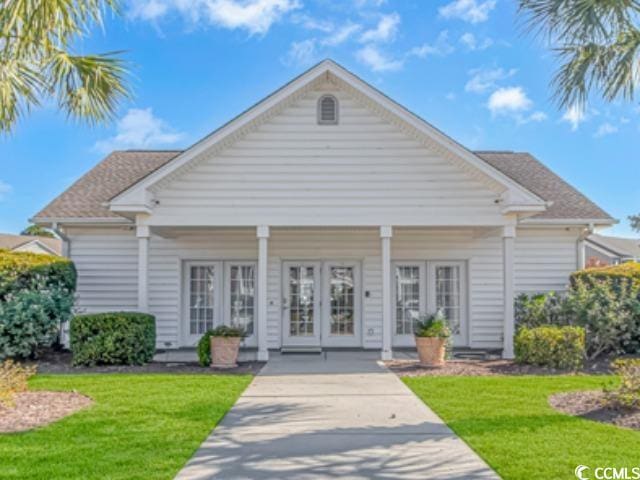 bungalow featuring french doors and a front yard