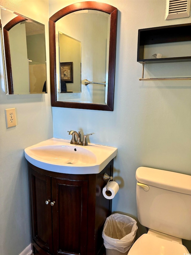 bathroom with vanity, a wall mounted AC, and toilet