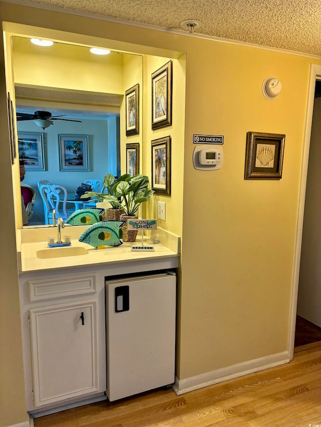 bathroom featuring vanity, hardwood / wood-style flooring, and ceiling fan