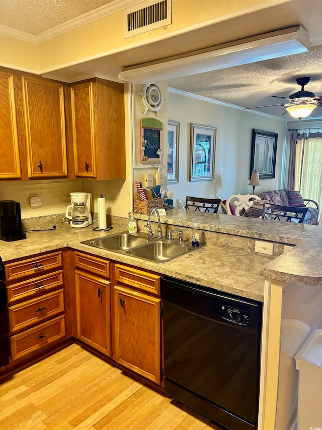 kitchen with sink, dishwasher, a textured ceiling, kitchen peninsula, and light hardwood / wood-style floors