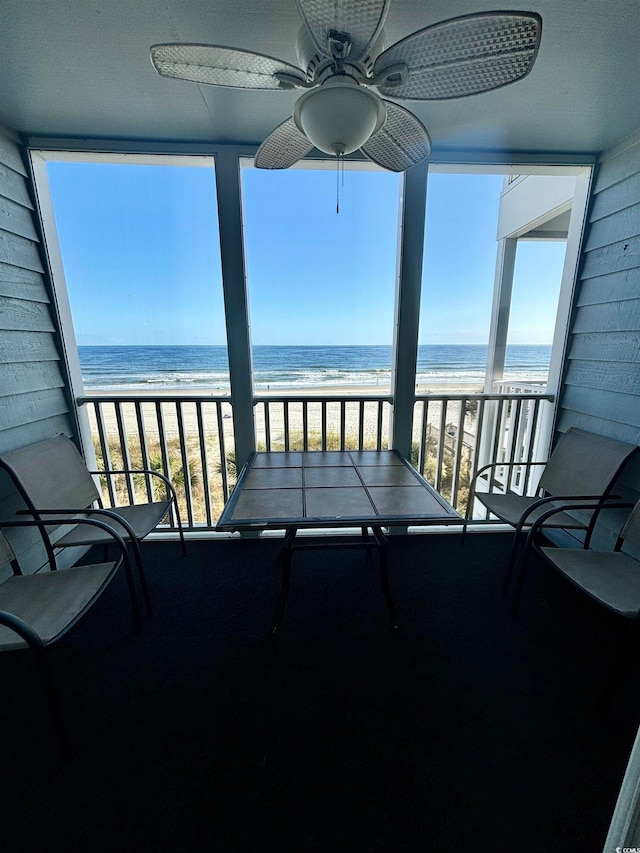 unfurnished sunroom featuring a water view and a healthy amount of sunlight